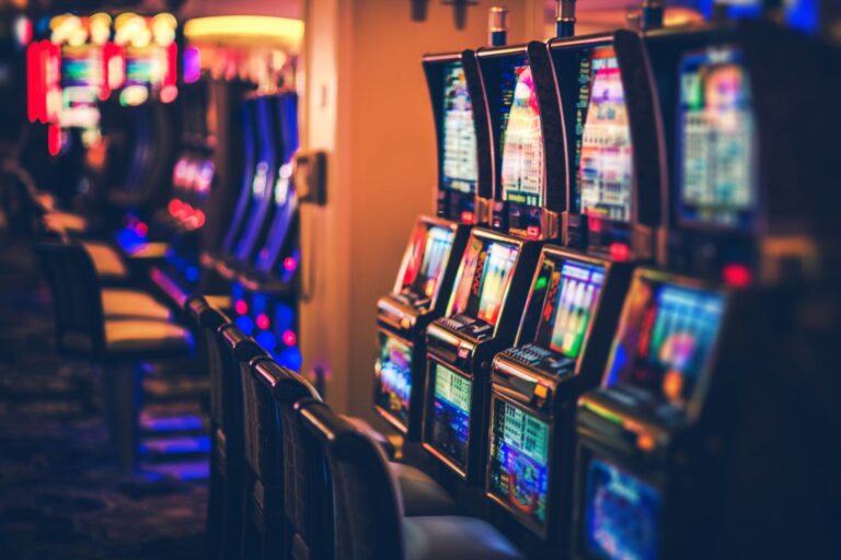 illuminated-slot-machines-in-darkroom-948708294-afaf089a8c7b4299aae1e1d70643a14c